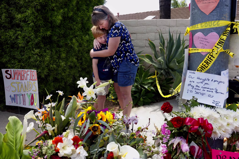 Image: Heather Foy and her son, Marshall, embrace at a memorial near the Chabad synagogue in Poway, California, on April 28, 2019.