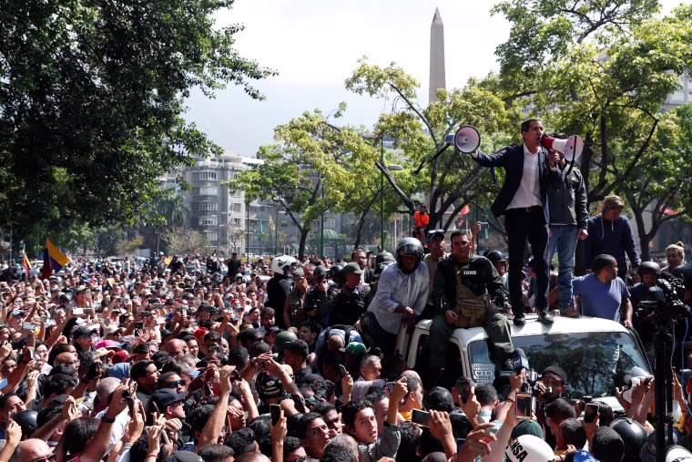 Image: Venezuelan opposition leader Juan Guaido, who many nations have recognised as the country's rightful interim ruler, talks to supporters in Caracas