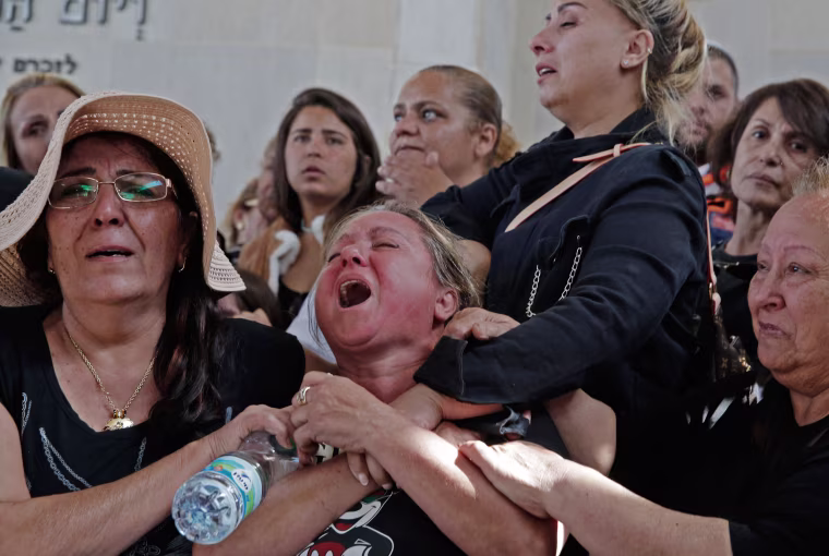 Friends and relatives mourn during the funeral of Moshe Agadi