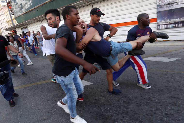 Image: An LGBT activist is detained by plain-clothed security personnel during a demonstration in Havana on May 11, 2019.