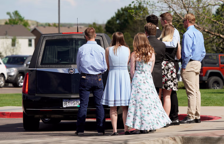 Image: Pallbearers watch the hearse leave after loading the coffin of shooting victim Kendrick Castillo of the Science, Technology, Engineering and Math (STEM) School after his memorial service in Highlands Ranch