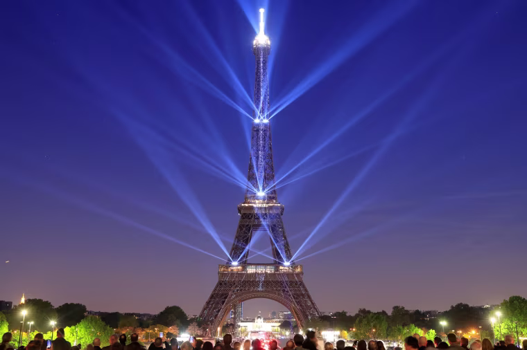 Image: The Eiffel tower is illuminated during a light show to celebrate its 130th anniversary in Paris