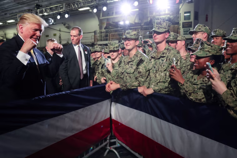 Image: U.S. troops take photos of U.S. President Trump aboard the USS Wasp in Yokosuka