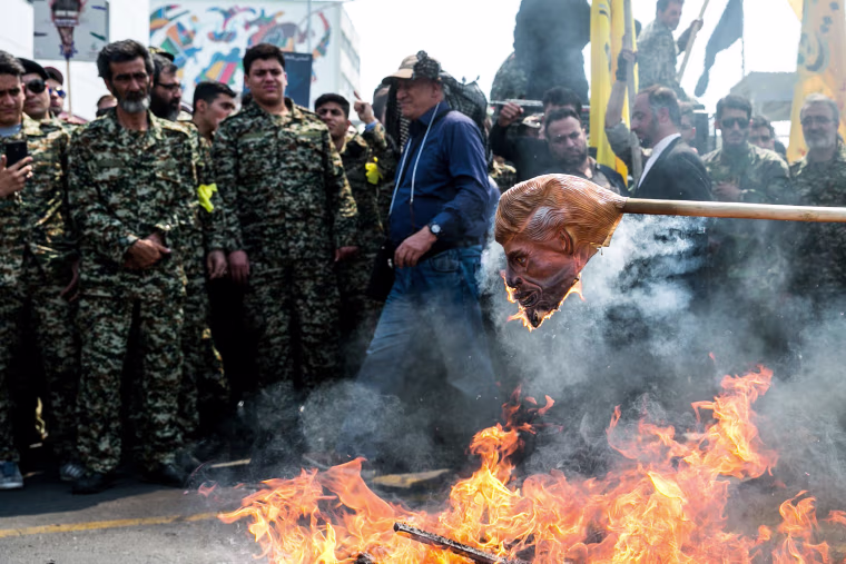 Image: Iranians burn a mask of President Donald Trump during a protest marking the annual al-Quds Day on the last Friday of the holy month of Ramadan