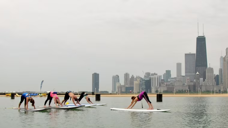 A yoga class being led by Chicago SUP on Lake Michigan.