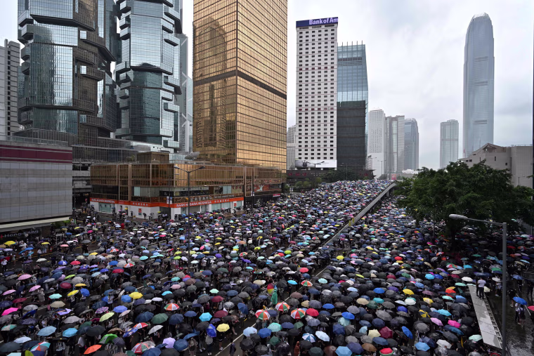 Protesters shelter under umbrellas during a downpour in Hong Kong 