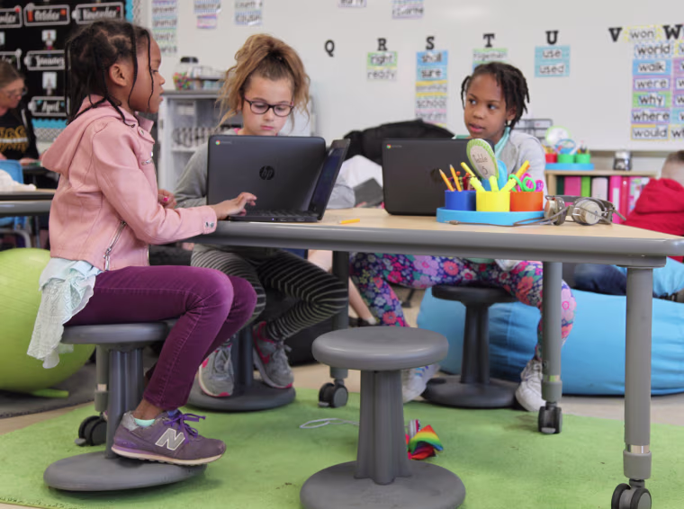 Wobble stools allow second graders, from left, Zariah Atwater, Juliette Ortiz and Kamilla Armstrong to rock and spin in between solving math problems at Thomas Hooker Elementary School.