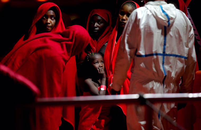 Image: Migrants wait to disembark from a boat after the were rescued on the Mediterranean Sea at the port of Malaga in Spain on Aug. 29, 2019.