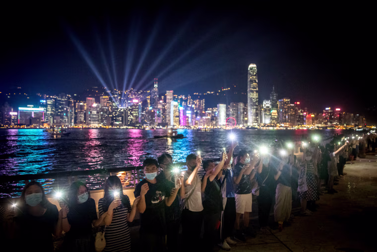 Image: Protesters hold hands to form a human chain along Hong Kong's Avenue of Stars on Aug. 23, 2019.