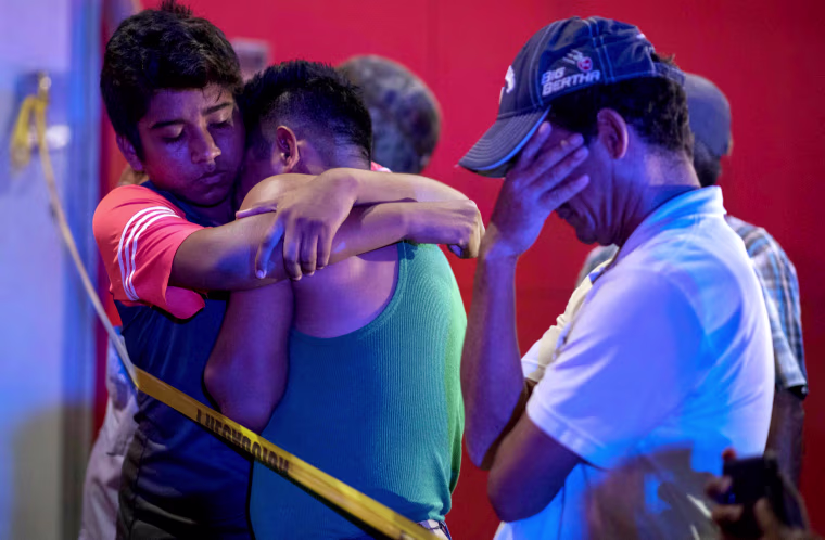 Image: Mourners hug after 23 people were killed in a fire at the Caballo Blanco bar in Coatzacoalcos, Mexico, on Aug. 28, 2019.