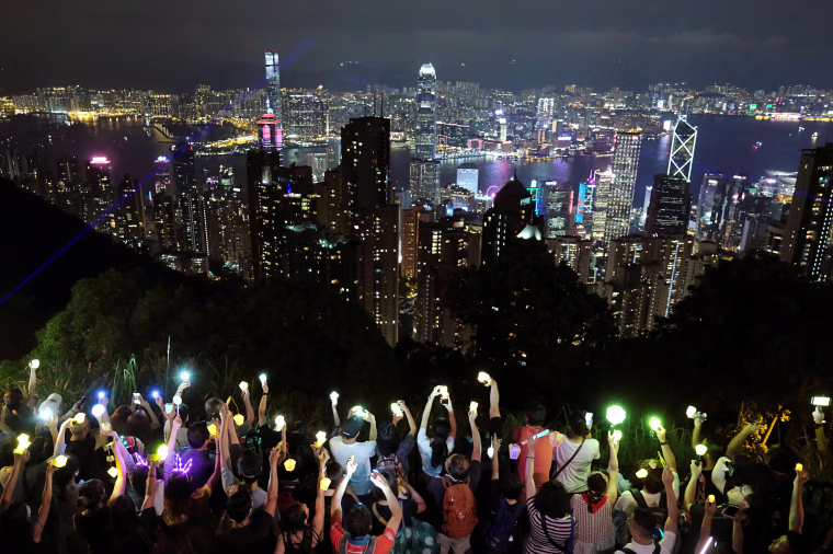Image: Anti-extradition bill protesters hold hands up to form a human chain during a rally to call for political reforms in Hong Kong