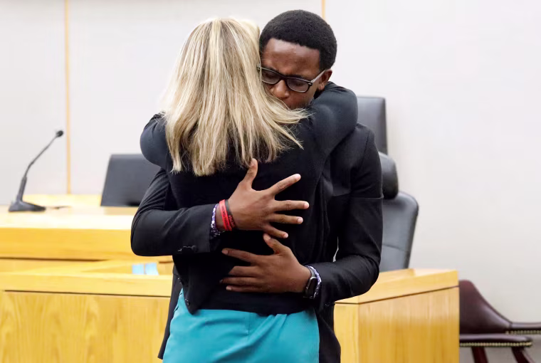 Image: Botham Jean's younger brother Brandt Jean hugs former Dallas police officer Amber Guyger