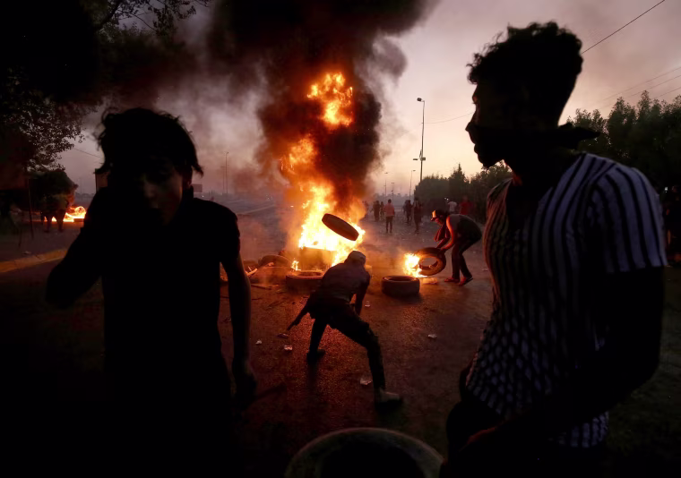 Image: TProtesters burn tires during a demonstration in Baghdad, Iraq, on Oct. 5, 2019.