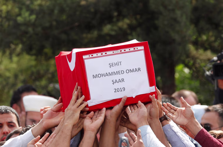 Image: People carry the Turkish flag-wrapped coffin of 9-month-old baby boy 