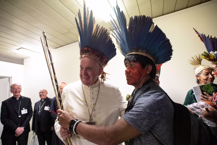 Image: Pope Francis wearing a headdress made of feathers meets with representatives of some of the Amazon's different ethnic groups