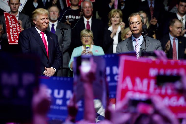Image: Republican presidential nominee Donald Trump watches as British pro-Brexit politician Nigel Farage speaks at a campaign rally in Jackson, Mississippi