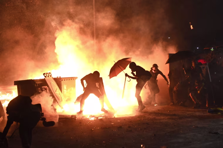 Protesters set up a fire during clashes with police at the Chinese University of Hong Kong (CUHK), in Hong Kong