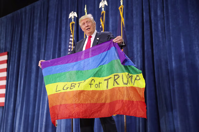 Image: Republican presidential nominee Donald Trump holds a rainbow flag
