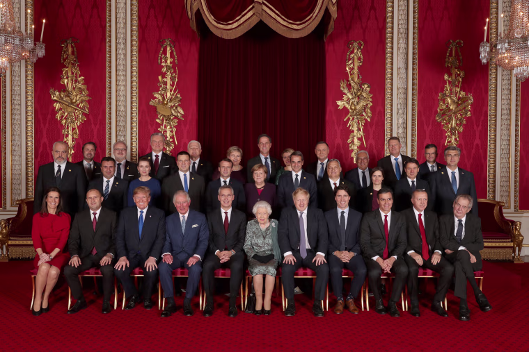 Image: Leaders of NATO alliance countries, and its secretary general, join Britain's Queen Elizabeth and the Prince of Wales for a group picture during a reception at Buckingham Palace