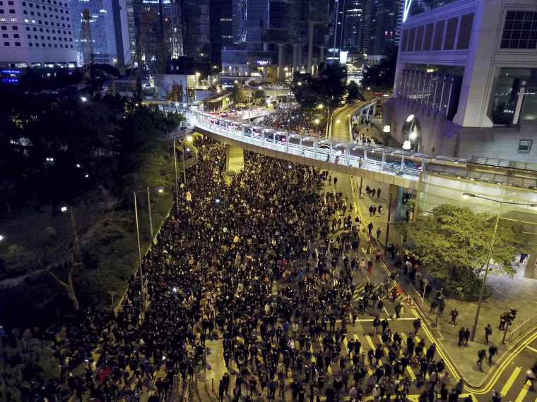 Protesters march into the night in Hong Kong on Dec. 8, 2019.