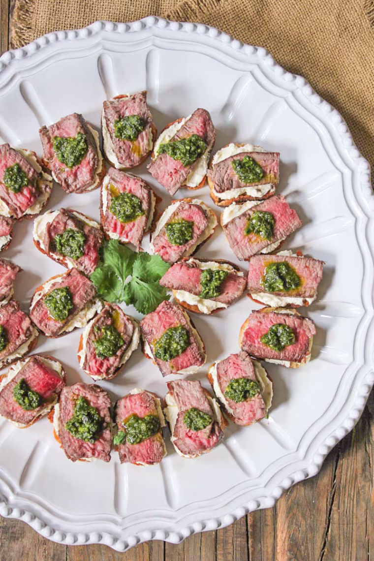 Beef tenderloin crostini with whipped goat cheese and pesto