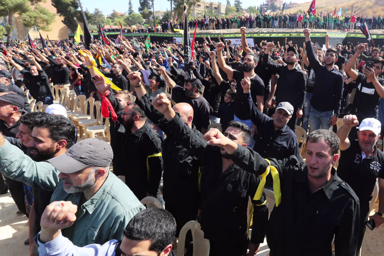 Image: Supporters of Lebanon's Hezbollah leader Sayyed Hassan Nasrallah gesture as they listen to his televised speech in Baalbeck