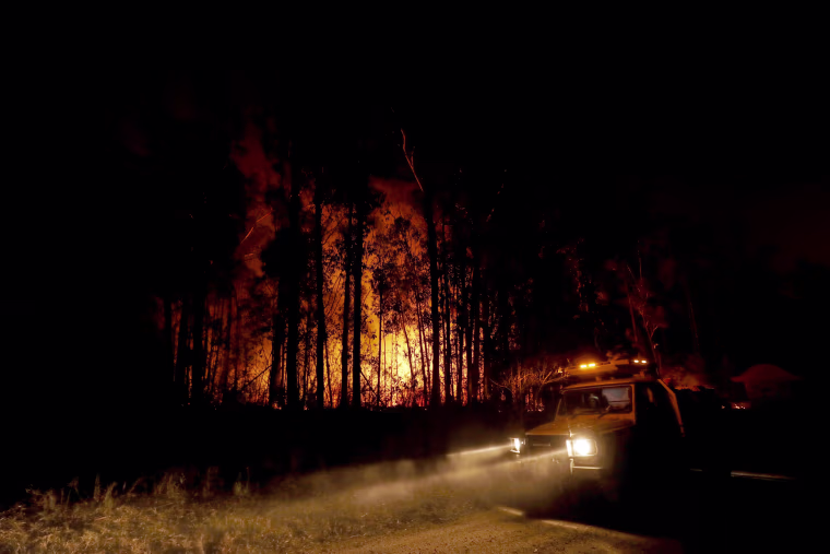 Image: Emergency crews monitor a fire burning between the towns of Orbost and Lakes Entrance near Mallacoota, Australia, on Jan. 2, 2020.