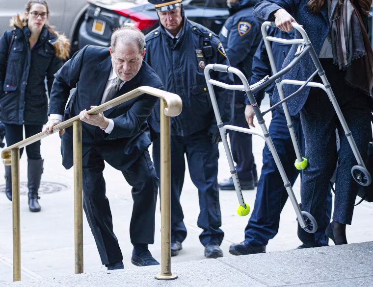 Harvey Weinstein climbs the courthouse steps in New York City on Jan. 8, 2020. Weinstein  pleaded not-guilty on five counts of rape and sexual assault against two unnamed women and faces a possible life sentence in prison.