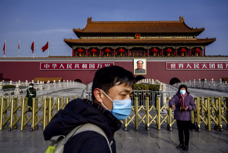 Image: A couple wears masks as they visit Tiananmen Gate in the midst of a coronavirus outbreak in Beijing on Jan. 24, 2020.