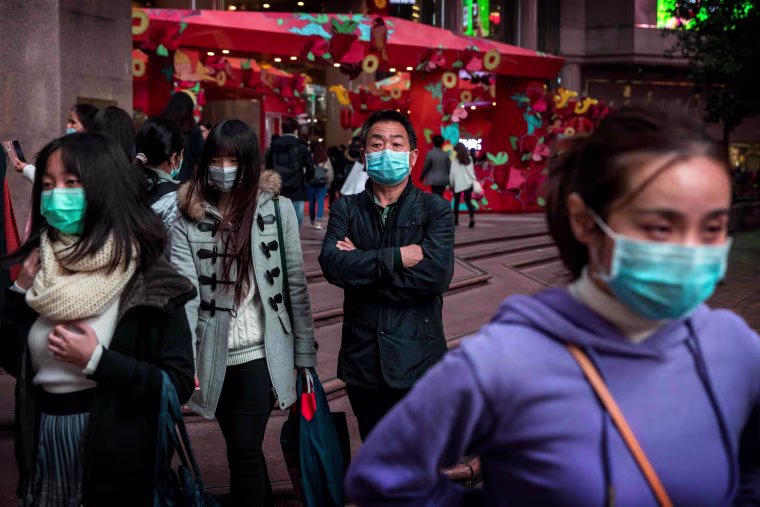 Image: People wear masks to protect against the coronavirus outbreak in Hong Kong on Jan. 26, 2020.