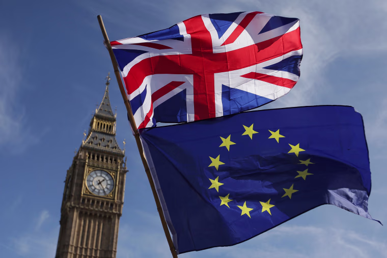 Image: An EU flag and a Union flag held by a demonstrator is seen with Elizabeth Tower (Big Ben) and the Houses of Parliament as marchers taking part in an anti-Brexit, pro-European Union (EU) in central London