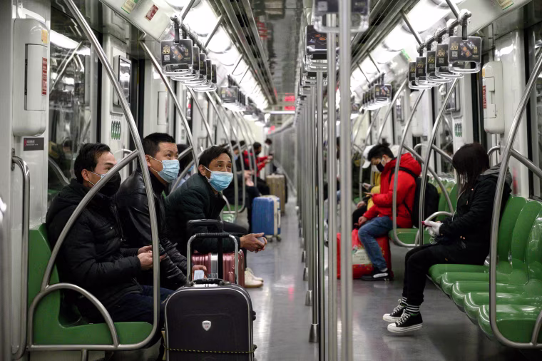 Image: Masked travelers in Shanghai