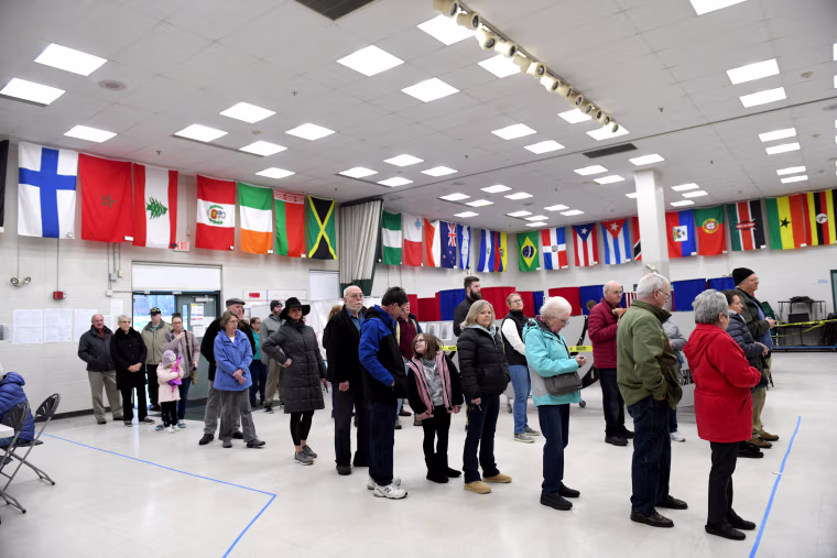 Image: Voters wait in line to cast their votes at the Bicentennial Elementary School in New Hampshire's first-in-the-nation U.S. presidential primary election in Nashua