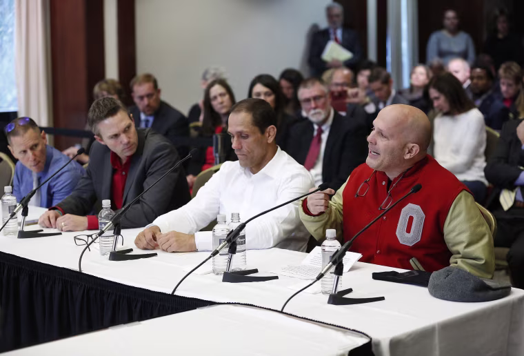 Michael DiSabato, right, speaks with other victims of former Ohio State team doctor Dr. Richard Strauss, at the university's board of trustees meeting on Nov. 16, 2018 in Columbus.
