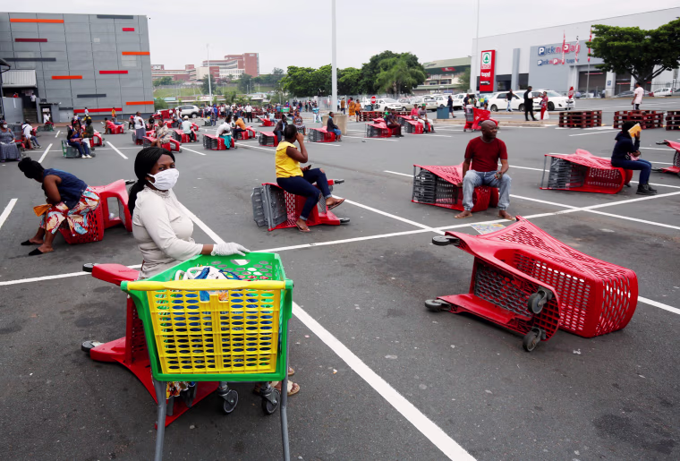 Image: Shoppers queue at a grocery store during a nationwide 21 day lockdown in an attempt to contain the coronavirus disease (COVID-19) outbreak in Chatsworth near Durban