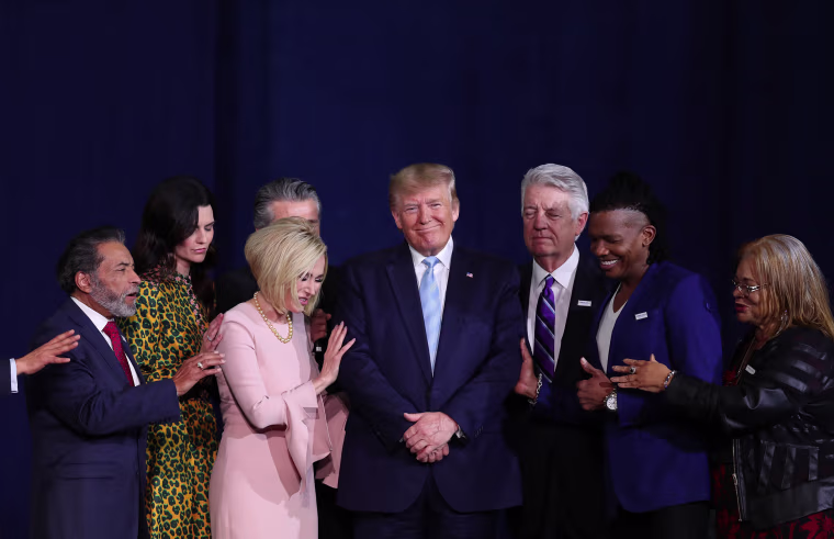 Faith leaders pray over President Donald Trump during an \"Evangelicals for Trump\" campaign event at the King Jesus International Ministry in Miami on Jan. 3, 2020.