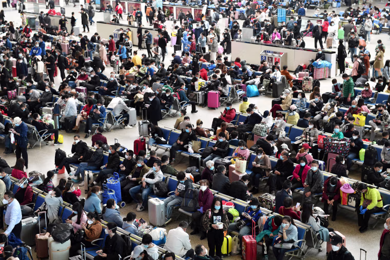 Image: Travellers are seen inside Hankou Railway Station in Wuhan