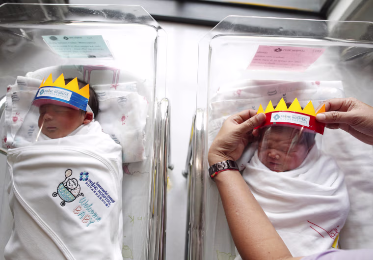 Image: Newborn baby wear face shield to prevent the COVID-19 coronavirus pandemic