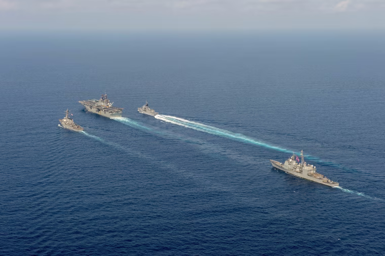 Image: RRoyal Australian Navy helicopter frigate HMAS Parramatta (top right) conducts officer of the watch manoeuvres with amphibious assault ship USS America, guided-missile destroyer USS Barry and guided-missile cruiser USS Bunker