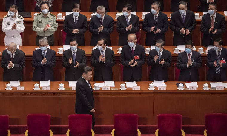 Image: Chinese president Xi Jinping is applauded by delegates wearing protective masks as he arrives at the opening of the National People's Congress on May 22, 2020 in Beijin