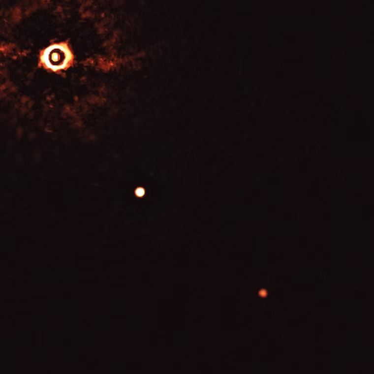 This image, captured by the SPHERE instrument on ESO's Very Large Telescope, shows the star TYC 8998-760-1 accompanied by two giant exoplanets. This is the first time astronomers have directly observed more than one planet orbiting a star similar to the Sun.