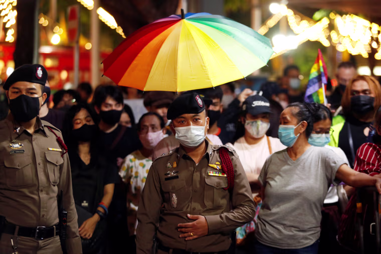 Image: Demonstrators hold a rainbow flag umbrella during a protest demanding the resignation of Thailand's Prime Minister Prayuth Chan-o-cha