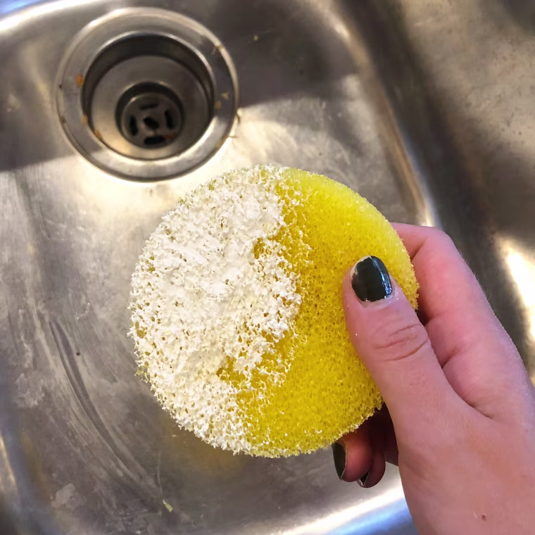 I coat one side of the sponge in the paste and use small, circular movements to eliminate stains and grime.