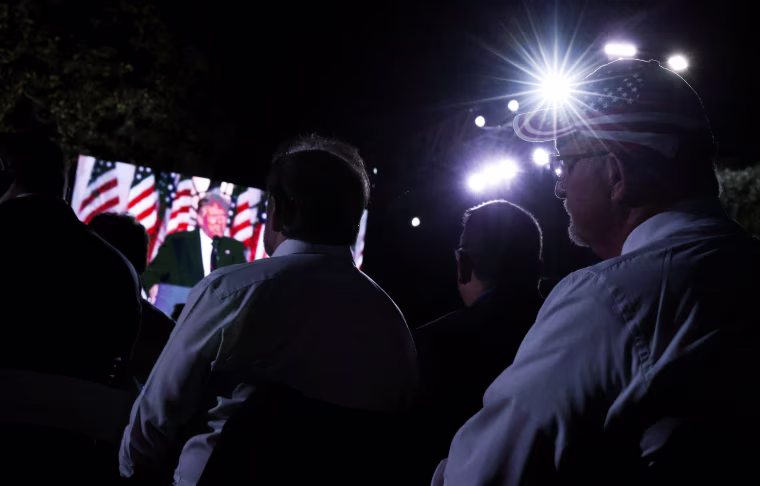Image: Supporters look on as President Donald Trump is seen on a screen as he delivers his acceptance speech as the 2020 Republican presidential nominee
