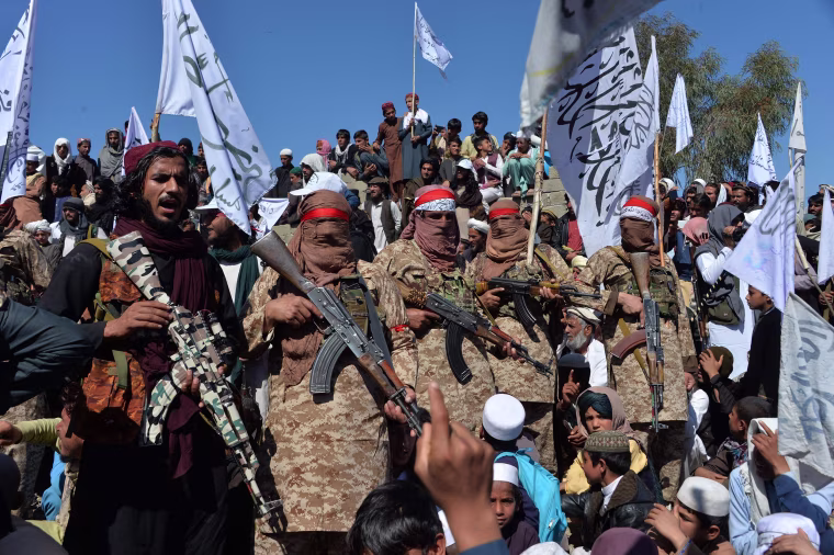 Image: Afghan Taliban militants and villagers attend a gathering as they celebrate the peace deal and their victory in the Afghan conflict on U.S. in Afghanistan