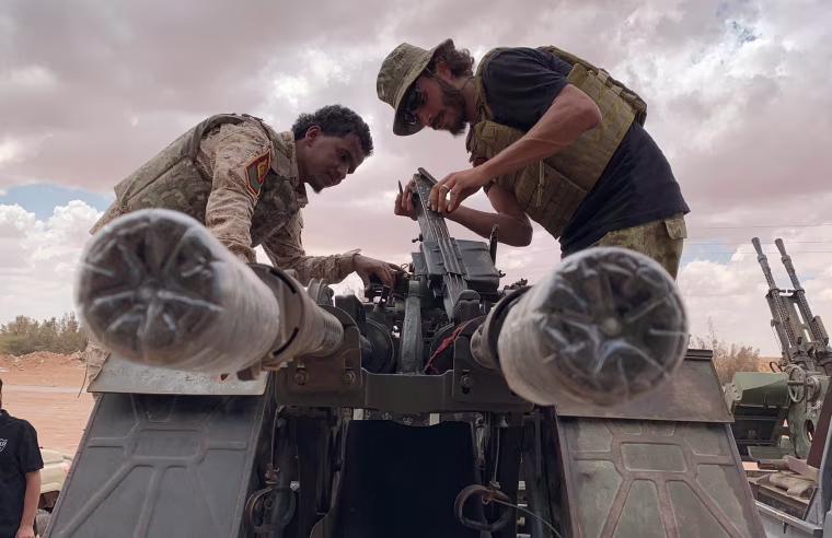 Image: Troops loyal to Libya's internationally recognized government prepare their weapon as they carry out patrols in Zamzam, near Abu Qareen, Libya