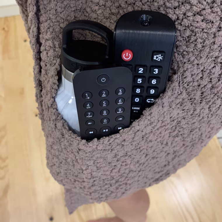 the sweater pocket can fit two remotes, my water bottle and more