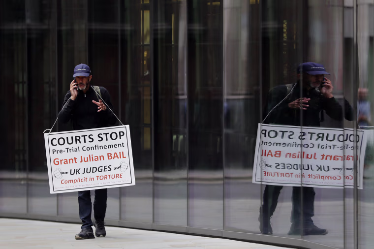 Image: A protester stands opposite London's Old Bailey court on Monday as the Julian Assange extradition hearing to the U.S. continued.