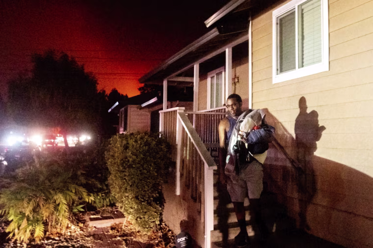 Image: Eddy Whitmore evacuates from his Santa Rosa, Calif., home as the Shady Fire approaches