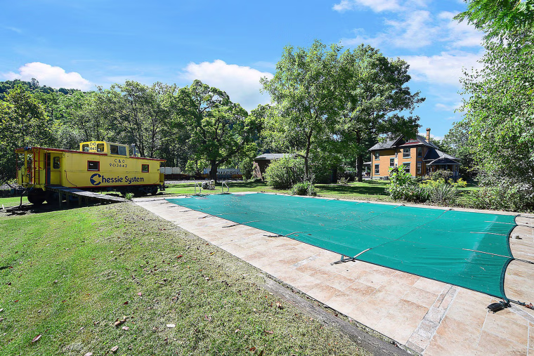 The closed pool has new tiling, while the vintage caboose provides a historical talking point.